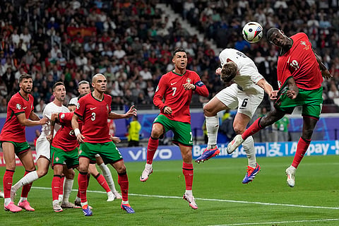 Nuno Mendes heads the ball next to Jaka Bijol